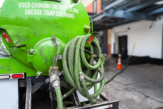 a grease trap pumping truck at a restaurant in Bronxville